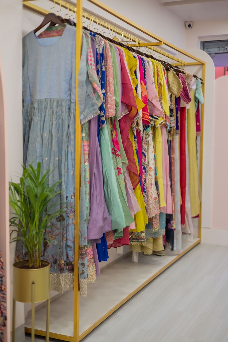 A boutique rack of pastel dresses